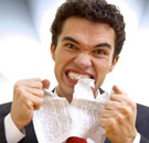 Annoying words and cliches - guy tearing paper with teeth
