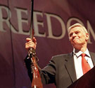 ...With liberty and ammo for all in power. Charlton Heston holding up a rifle