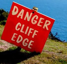 Proceed only with enough knowledge to die correctly. Danger Cliff Edge warning sign