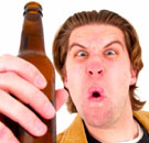 Mad college guy holding a beer and taunting someone to fight
