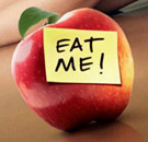 Apple with Post-It note saying "EAT ME!"