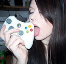 Girl licking a Nintendo Wii controller