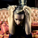 Girl sitting and pulling her hair out