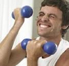 Man lifting small weights in the gym