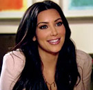 The face that says, 'Did I like, lose an IQ digit in the couch??' Kim Kardashian smiles on her reality TV show
