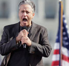 Jon Stewart yelling into a microphone at his Rally for Sanity