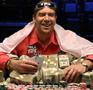 Go ahead, let your greed loose. Poker player with a pile of cash winnings at poker table