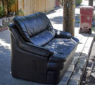 Leather sofa on the curb to be taken away as trash