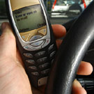Cars just aren't functional anymore Dialing cell phone in front of steering wheel