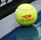US Open tennis ball sitting in a puddle