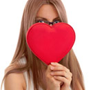 Go ahead, rip a hole in my heart. Girl holding a heart in front of her face