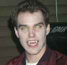 Yep, he's gonna whet her appetite for YOU. Guy dressed as a vampire with fangs and green eyes