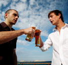 Two guys cheersing with beers