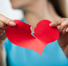 Origami was never really your thing anyway, right? Woman tearing a paper heart