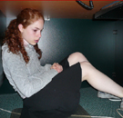 Jodie Hampton retreats to what she considers 'a safe place' in the WVU library. Girl sitting sadly under a table in the library
