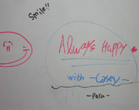 Whiteboard writing from KC's students - 'ALWAYS HAPPY WITH CASEY'