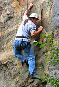 Andrei on a rock face climbing