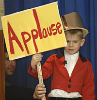 Kid holding an applause sign
