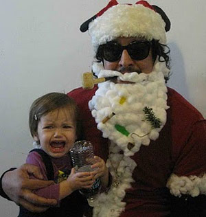 Bad scruffy Santa with a crying kid on his lap
