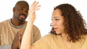 Black man pleading with his wife for forgiveness