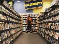 Woman renting DVD from Blockbuster.