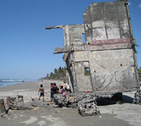House built on the sand leaning about to topple over