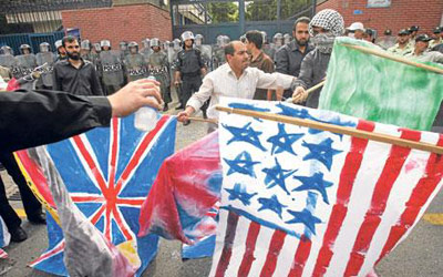 Burning USA and British flags in Iran