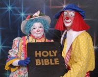Two clowns posing holding a Bible