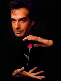 David Copperfield dressed in all black levitating a rose