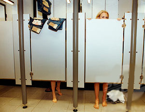 Woman in a dressing room with her feet and head exposed