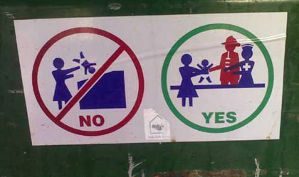 Sign on a dumpster saying not to throw baby away in it