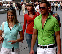 European male tourist in tight shirt and white pants
