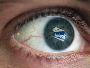 Human eye with Facebook logo reflection in it