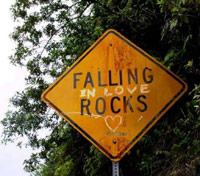 Falling in love rocks road sign