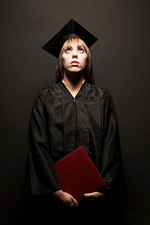 Girl in graduation gown, scared