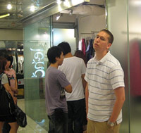 Guy standing around bored inside the shopping mall