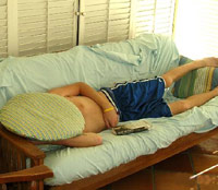 Guy sleeping on a futon
