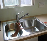 Sink with a hand coming out of it