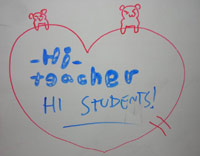 Whiteboard drawing from KC's students - 'HI TEACHER'