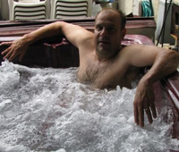 Man relaxing in a hot tub