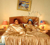 Frustrated couple in a hotel bed