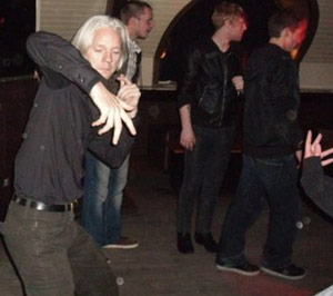 Julian Assange dancing at a bar