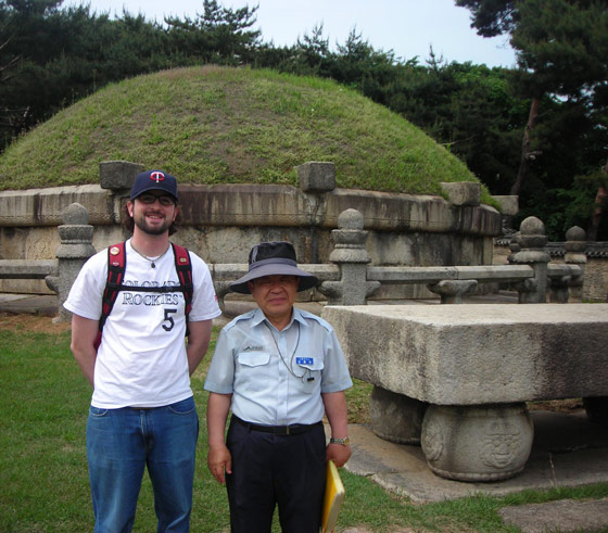 Kevin Freeman with a short Korean tour guide in front of a burial mound