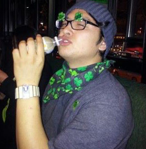 Korean guy in green St. Paddy's Day stickers and bandana