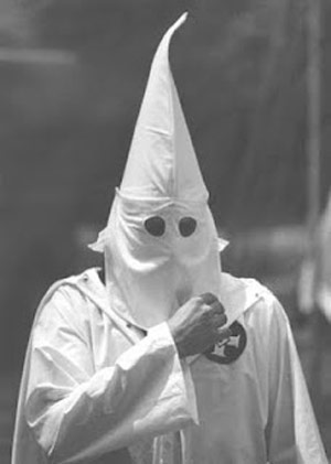Ku Klux Klan member in a white robe and hood