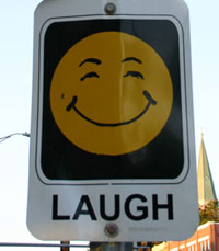 Laugh sign on the street with smiley face