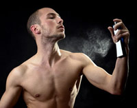 Man spraying perfume on his body