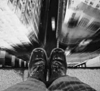 Man looking over a ledge thinking about jumping to commit suicide