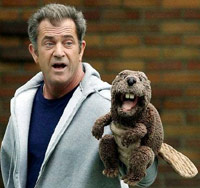 Mel Gibson with a beaver puppet on his hand