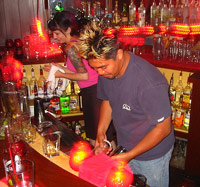 Guy barbacking behind a bar